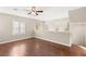 Bright living room with hardwood floors, ceiling fan, and plantation shutters on the windows at 1968 Granemore St, Las Vegas, NV 89135