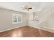 Open-concept living room features wood floors, a ceiling fan, neutral paint, and great natural lighting at 1968 Granemore St, Las Vegas, NV 89135