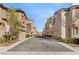 Street view of beige homes with tile roofs, garages, and well-maintained landscaping at 1968 Granemore St, Las Vegas, NV 89135