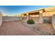 Enclosed backyard with gravel cover, rock border, covered patio, privacy wall and AC unit at 209 Roxborough St, Henderson, NV 89074