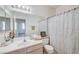 Cozy bathroom with a single vanity, large mirror, and shower-tub combo for everyday needs at 209 Roxborough St, Henderson, NV 89074