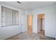 Bright bedroom featuring a large window, neutral carpet, and two accessible doorways at 209 Roxborough St, Henderson, NV 89074