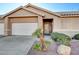 Lovely single-story home with desert landscaping and an attached two-car garage at 209 Roxborough St, Henderson, NV 89074