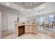 Open concept kitchen with granite counters, wooden cabinets, black dishwasher, and view to the dining area at 209 Roxborough St, Henderson, NV 89074