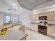 Well-lit kitchen with light wooden cabinets, granite countertops, and modern appliances for an efficient cooking experience at 209 Roxborough St, Henderson, NV 89074