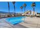 A pristine community pool with surrounding palm trees offers a resort-style ambiance at 209 Roxborough St, Henderson, NV 89074