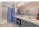 Neutral bathroom featuring a double sink vanity, tile flooring, and shower-tub combo at 2325 Windmill Pkwy # 323, Henderson, NV 89074