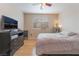 Inviting bedroom featuring hardwood floors, black dresser and large window with blinds at 2325 Windmill Pkwy # 323, Henderson, NV 89074