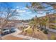 Serene courtyard view showcasing manicured shrubs and mature trees with parking in the background at 2325 Windmill Pkwy # 323, Henderson, NV 89074