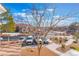 View of building with parking and landscaping featuring manicured trees and shrubs at 2325 Windmill Pkwy # 323, Henderson, NV 89074