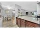 Open kitchen and dining area featuring wood cabinets and view of the living room at 2451 N Rainbow Blvd # 1006, Las Vegas, NV 89108