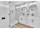 Bright bathroom featuring double vanity, modern fixtures, and tiled shower with marble accents at 3137 Sunrise Cove Ave, North Las Vegas, NV 89031