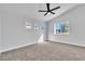 Spacious bedroom featuring a modern ceiling fan and three sunny windows at 3137 Sunrise Cove Ave, North Las Vegas, NV 89031