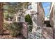 Home exterior featuring landscaped front yard, trees, and a brick wall at 3137 Sunrise Cove Ave, North Las Vegas, NV 89031