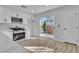 Modern kitchen featuring stainless steel appliances and light-filled sliding glass doors at 3137 Sunrise Cove Ave, North Las Vegas, NV 89031