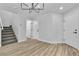 Well-lit living room featuring modern lighting, hardwood floors, and staircase at 3137 Sunrise Cove Ave, North Las Vegas, NV 89031