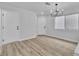 Minimalist-style living room featuring wood flooring and modern lighting at 3137 Sunrise Cove Ave, North Las Vegas, NV 89031