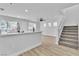 Open-concept living room with modern finishes, stairs, and plenty of natural light at 3137 Sunrise Cove Ave, North Las Vegas, NV 89031