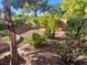 Cozy backyard space featuring rock landscaping, lush bushes, and decorative stone borders at 3337 Autumn Veil St, Las Vegas, NV 89129