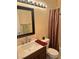 Bathroom with shower and tub combo, dark vanity, and a well-lit mirror at 3337 Autumn Veil St, Las Vegas, NV 89129