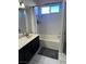 Bathroom featuring a tub and shower combo, dark vanity and light colored tile flooring at 3337 Autumn Veil St, Las Vegas, NV 89129