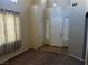 Bright foyer featuring neutral walls, tile and carpet flooring, and a high ceiling leading into the living area at 3337 Autumn Veil St, Las Vegas, NV 89129