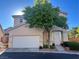 Two-story home with a two-car garage and well-maintained front yard landscaping and a mature shade tree at 3337 Autumn Veil St, Las Vegas, NV 89129