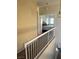 Hallway with white railings providing a view into a bedroom with a comfortable bed at 3337 Autumn Veil St, Las Vegas, NV 89129