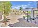 Inviting backyard with patio, artificial turf, gravel and an outdoor umbrella at 343 American Dipper St, Las Vegas, NV 89138