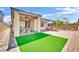 Spacious backyard featuring artificial turf, brick pavers and covered patio at 343 American Dipper St, Las Vegas, NV 89138