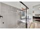 Modern bathroom showcasing a glass-enclosed shower and soaking tub with views of the Primary bedroom at 343 American Dipper St, Las Vegas, NV 89138