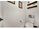 Neutral powder room featuring starfish art, floating shelves, and a contemporary toilet at 343 American Dipper St, Las Vegas, NV 89138