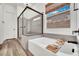 Elegant bathroom featuring a soaking tub, separate shower, and a window bringing in natural light at 343 American Dipper St, Las Vegas, NV 89138