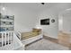 Contemporary bedroom featuring a daybed, crib, and mounted television at 343 American Dipper St, Las Vegas, NV 89138