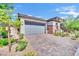 Beautiful home exterior with a paved driveway and gray garage door at 343 American Dipper St, Las Vegas, NV 89138