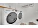 Modern laundry room with side-by-side washer and dryer and ample storage at 343 American Dipper St, Las Vegas, NV 89138