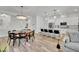 Open-concept living space with dining area and a modern kitchen featuring a large island and pendant lighting at 343 American Dipper St, Las Vegas, NV 89138