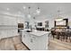 Modern kitchen with a large island that adjoins the dining and living areas at 343 American Dipper St, Las Vegas, NV 89138