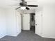 Bedroom featuring neutral paint, carpeted floors, and three white doors leading to other rooms at 3539 Japan Way, Las Vegas, NV 89115