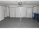 Spacious garage with epoxy flooring and white walls, featuring a large white garage door at 3539 Japan Way, Las Vegas, NV 89115