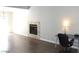 Cozy living room showcasing a fireplace, laminate floors, and versatile space ideal for both relaxation and work at 3539 Japan Way, Las Vegas, NV 89115