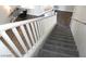 Carpeted staircase with white banister and wood floors, offering a bright and welcoming entrance to the home at 3539 Japan Way, Las Vegas, NV 89115