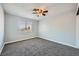 This bedroom features soft gray walls, a window for natural light, and plush carpeting at 3675 Winner Dr, Las Vegas, NV 89120