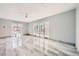 A bright living room with tile floor and lots of natural light from the sliding doors at 3675 Winner Dr, Las Vegas, NV 89120