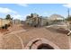 Spacious backyard with gravel, fire pit, shed, patio, and covered parking at 4272 E Russell Rd, Las Vegas, NV 89120