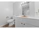 Bathroom featuring white vanity and toilet with neutral walls and vinyl flooring at 4272 E Russell Rd, Las Vegas, NV 89120