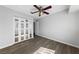 Bedroom with ceiling fan, wood-look floors and mirrored closet doors at 4272 E Russell Rd, Las Vegas, NV 89120