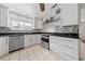 Bright kitchen featuring white cabinets, stainless steel appliances, granite countertops and neutral tile flooring at 4272 E Russell Rd, Las Vegas, NV 89120