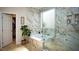 Spa-like bathroom with soaking tub, elegant tilework, and a separate shower stall at 5059 Pensier St, Las Vegas, NV 89135