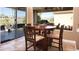 Bright dining area with cozy seating and sliding glass doors leading to a screened in patio at 5059 Pensier St, Las Vegas, NV 89135